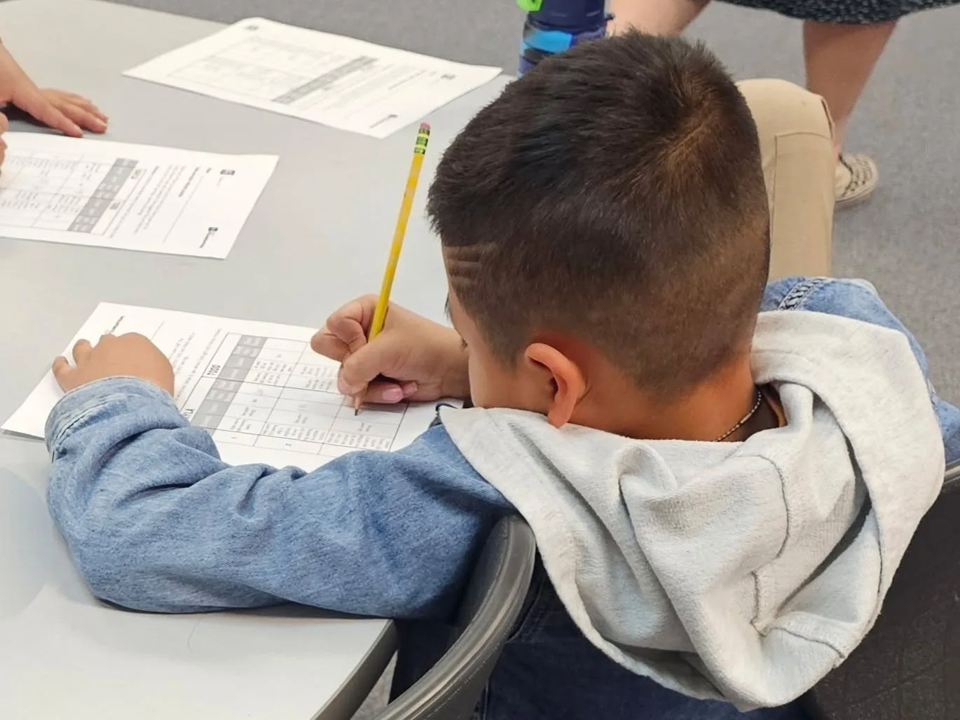 A Colorado Springs School District 11 student works at his desk.